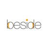 beside